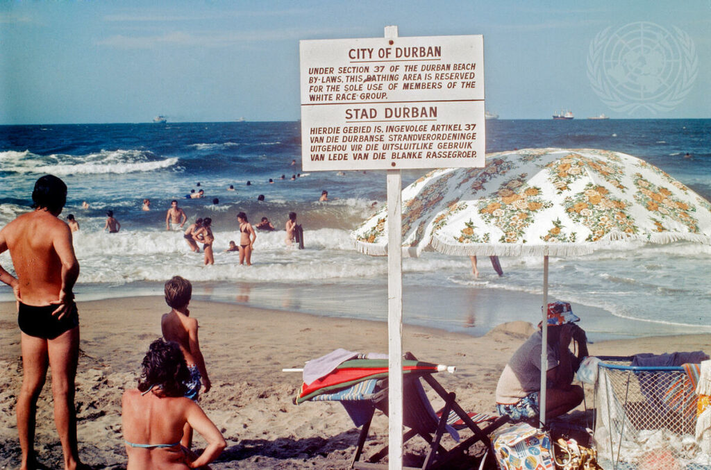 IMAGE: A UN photo depicting a sign on a beach that designates an area for whites only 