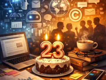 IMAGE: A birthday cake with lit candles shaped “23” on a desk with a laptop, books, coffee, and papers. In the background, digital icons and silhouettes of people suggest technology, data, and conversation