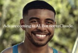 IMAGE: A screen capture of a Super Bowl ad by Anthropic, with a personal trainer smiling and, over imposed, a text reading "Ads are coming to AI. But not to Claude"
